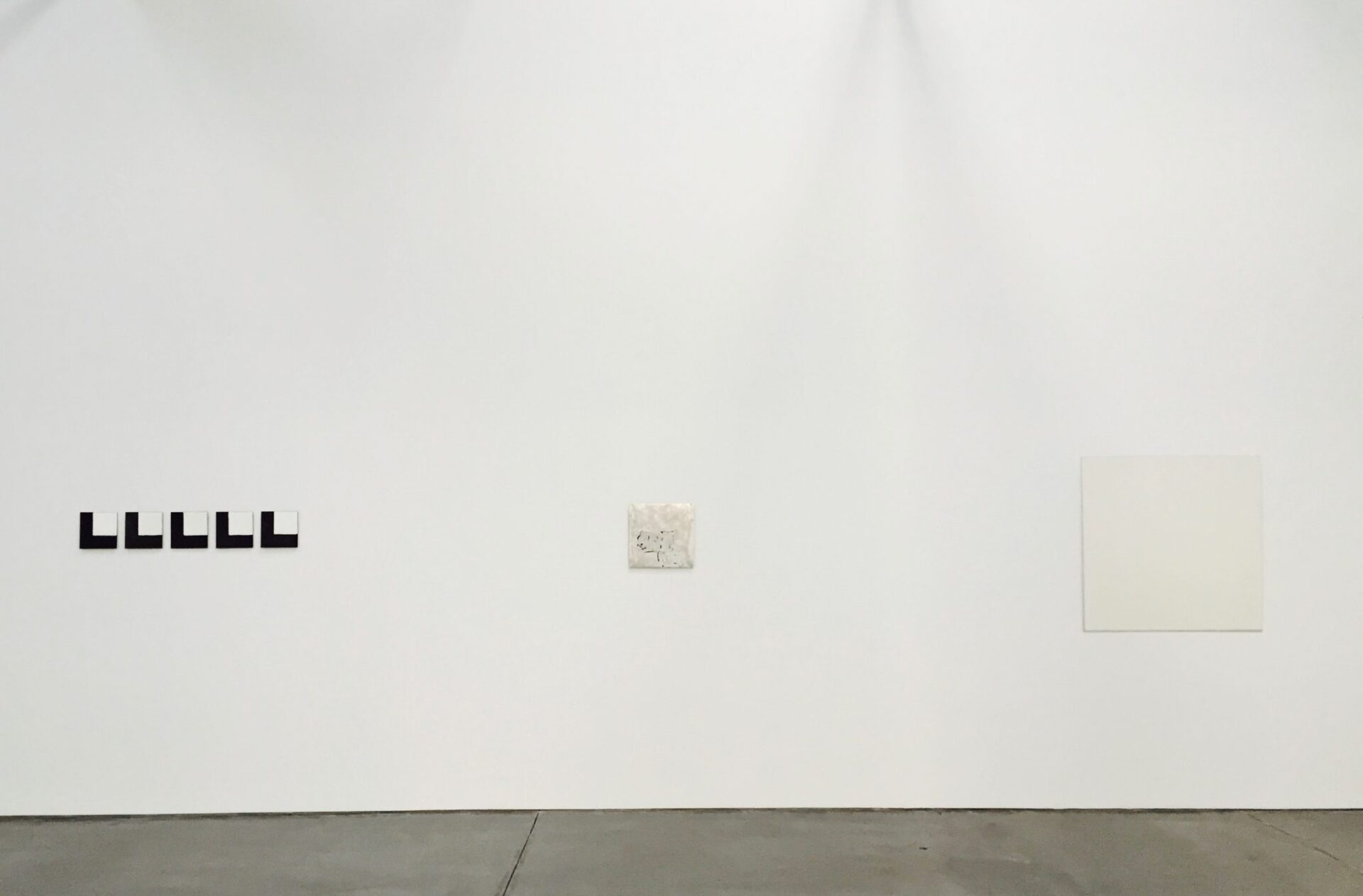 Robert Ryman. Gallery 2, installation view of the south wall. Ryman used manifold ways of distributing paint on a surface, including firing. The work on the left, Untitled, 1973, consists of double-baked vitreous enamel on oxidized copper. 